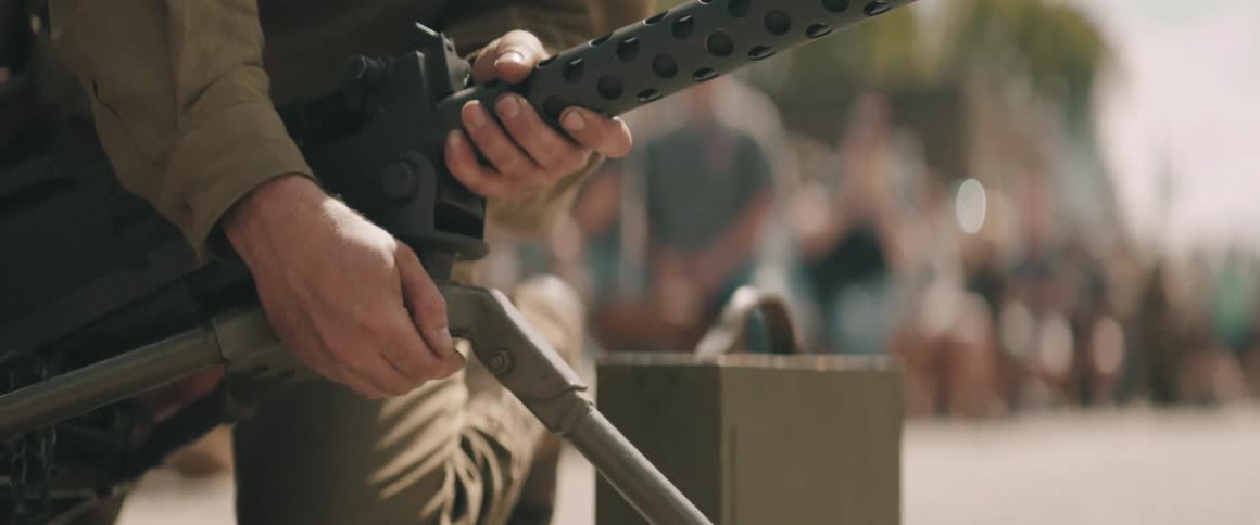 A soldier setting up a gun