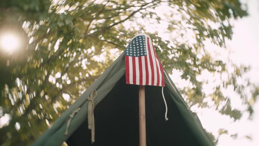 A close up of a flag and tent outdoors