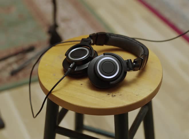 Headphones sitting on a stool in a room