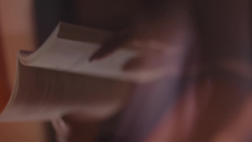 The woman is reading the book