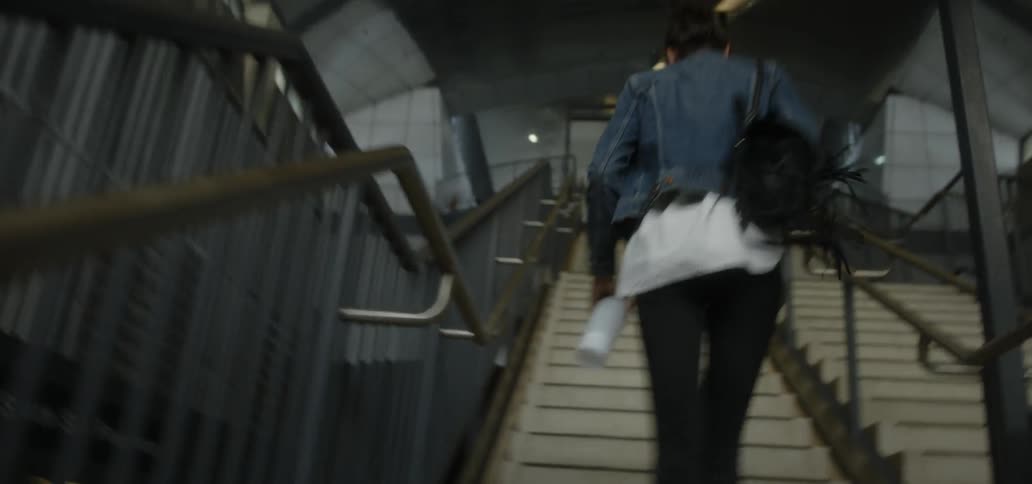 Woman runs quickly up the stairs
