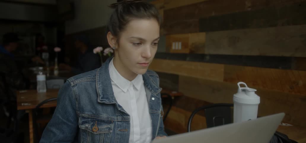 A woman works on a laptop in a restaurant