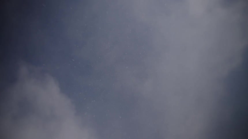 Snowflakes falling from a cloudy sky