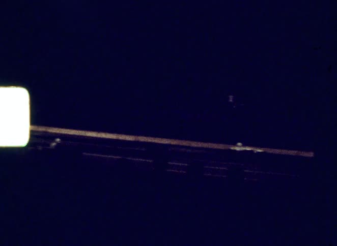 Two race cars speed down the track