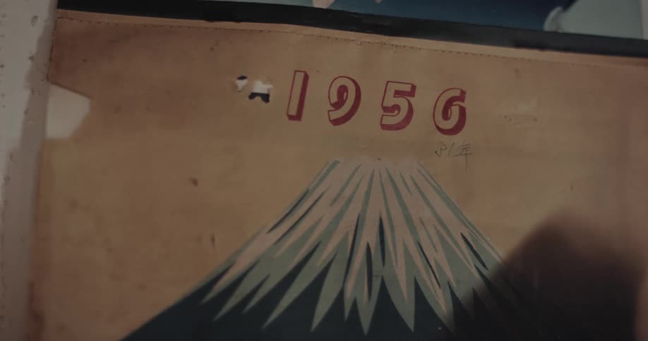 Stylized mountain beneath the number 1956 on worn beige background