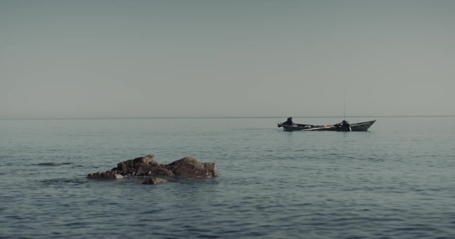 Small boat floating calmly on an ocean