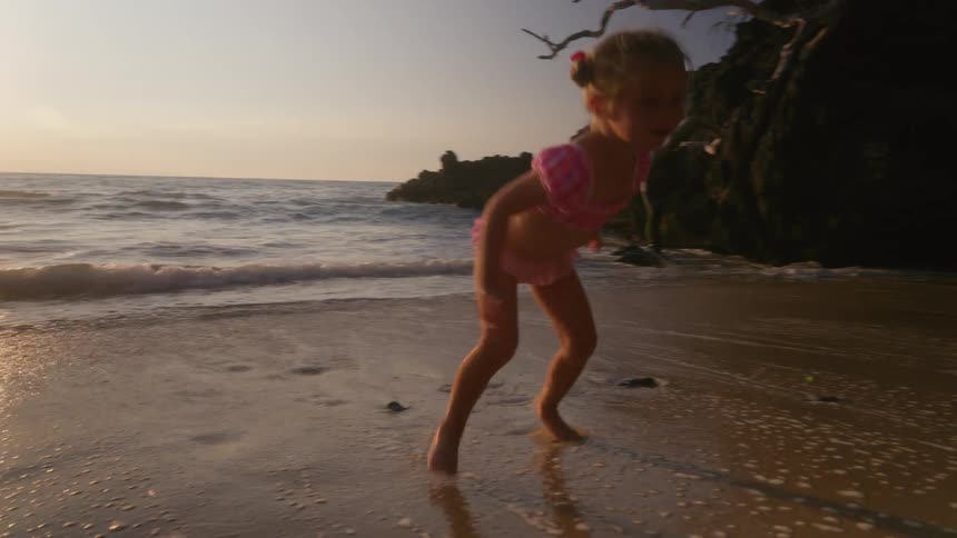 A child playing at the beach