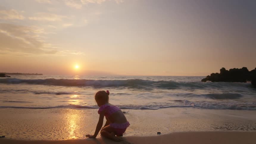 A child playing on a beach