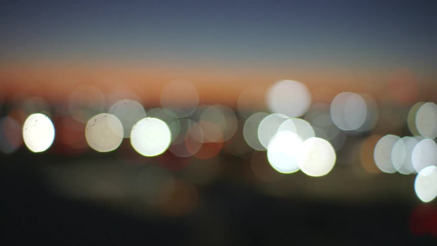 Blurred city lights glow at nightfall