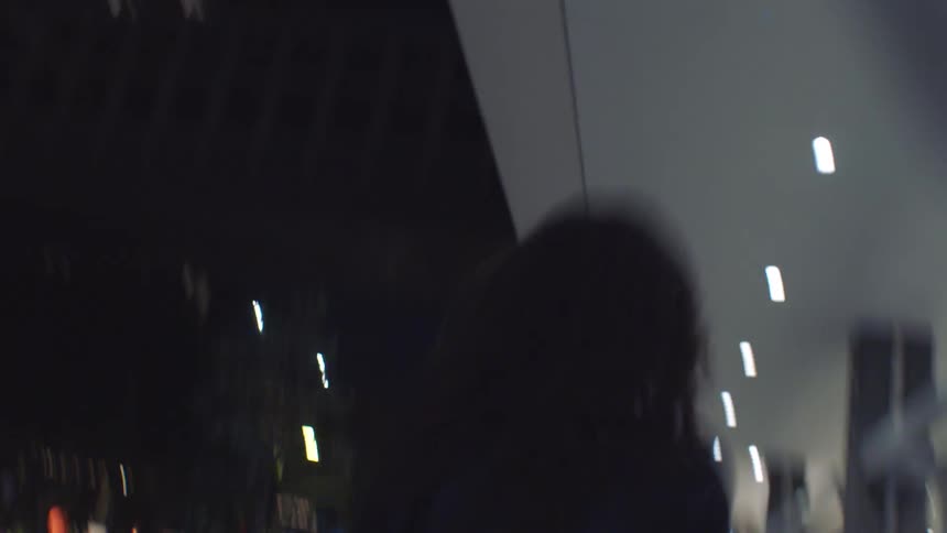 Two women walking in a city at night