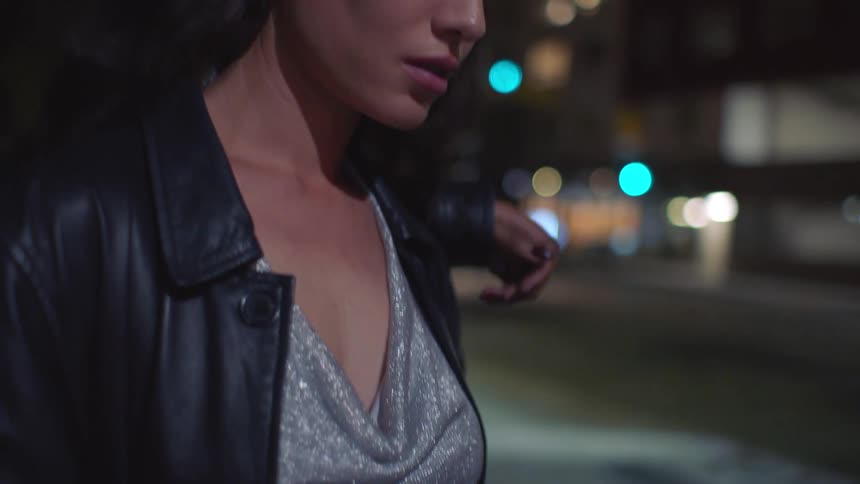 A woman standing outdoors texting