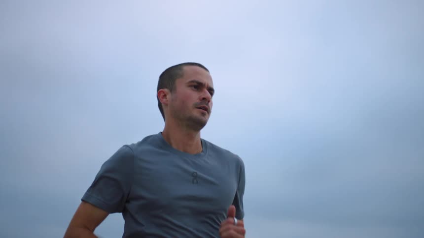 The man is running on a cloudy day