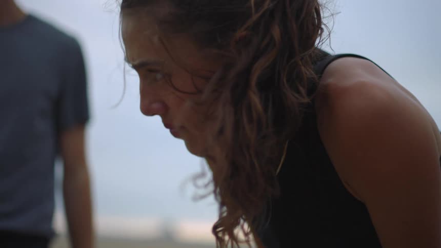 Close up portrait of a young woman during an outdoor fitness session in daytime
