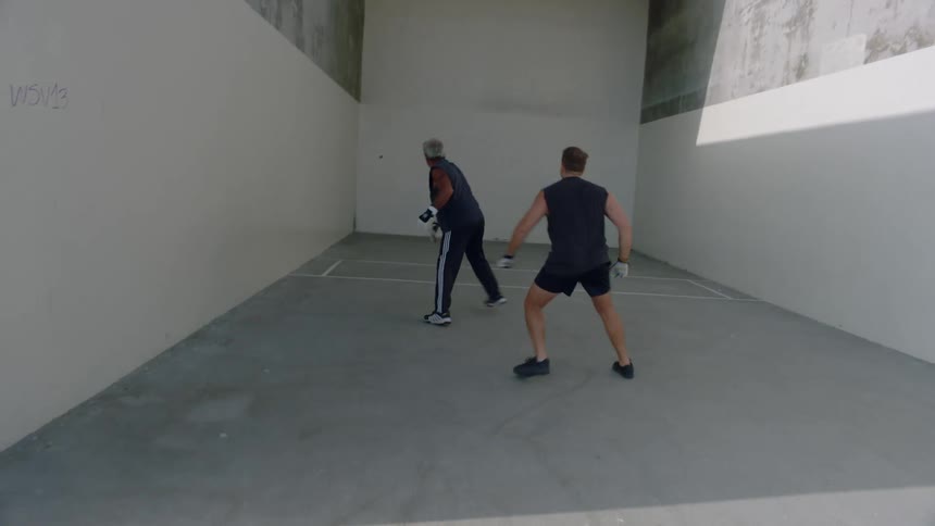 Two men playing handball outdoors during daytime
