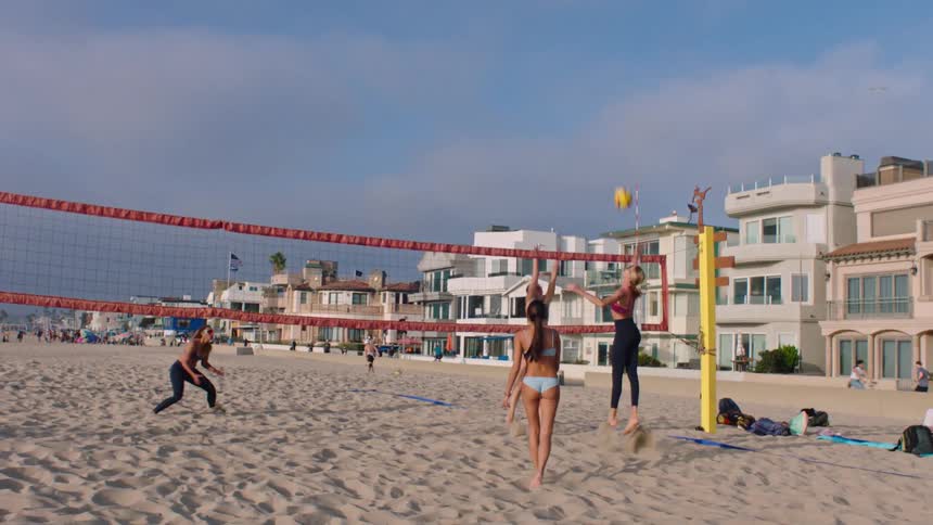 Pair scoring a point in a beach volleyball match