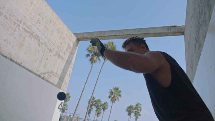 A man playing handball outdoors during daytime