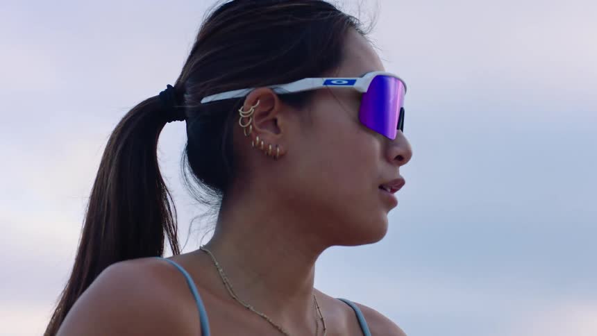 Woman wearing sunglasses outdoors looking around