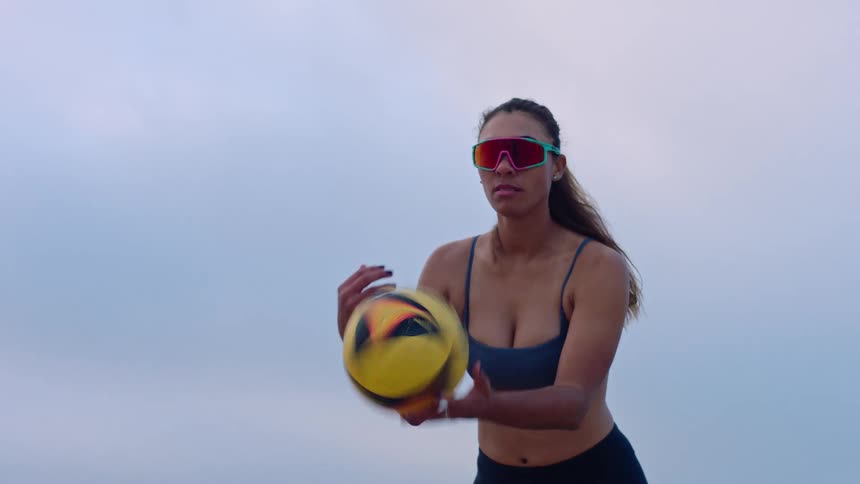 A woman serving a volleyball