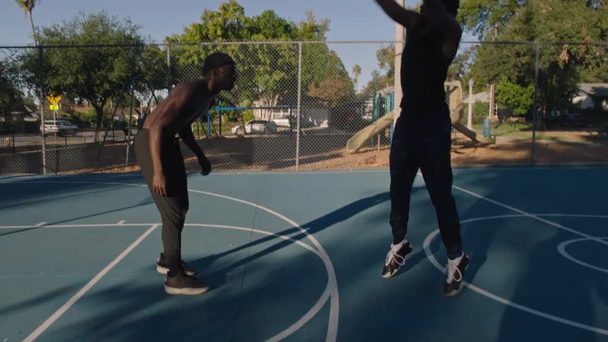 Two men playing basketball