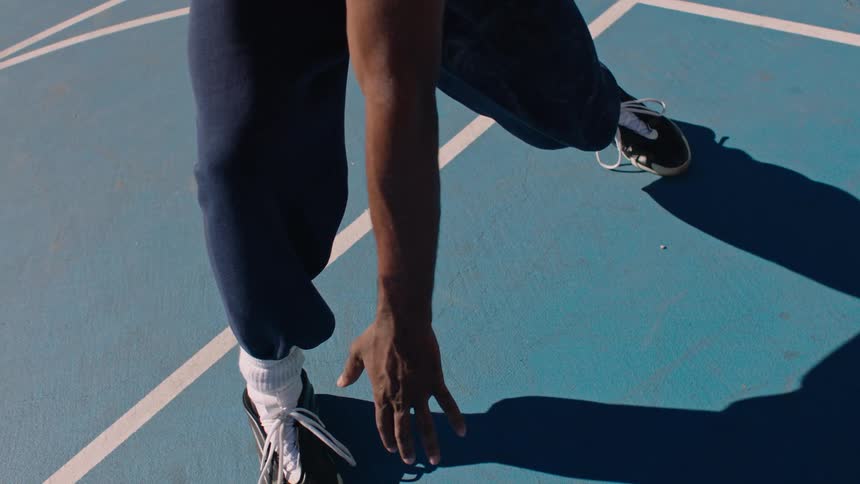 Person dribbling a basketball on a court