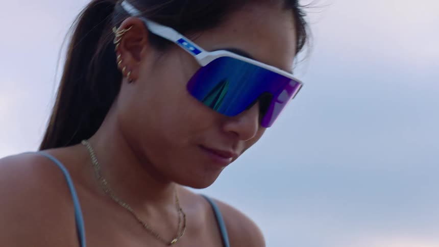 A woman holding a volleyball outdoors