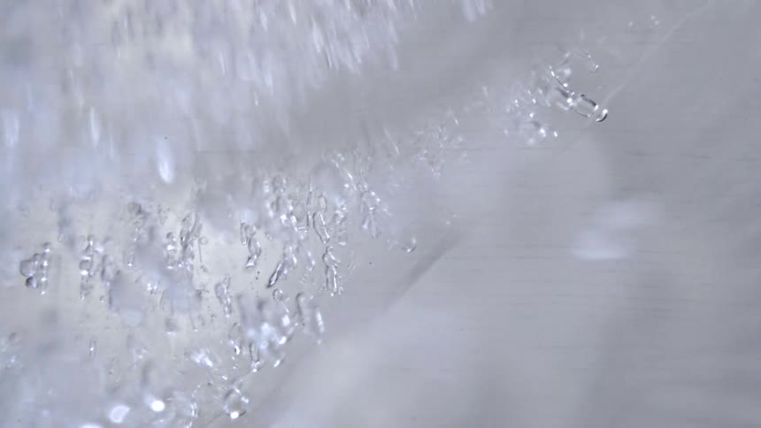 Translucent ice with irregular fragments and internal bubbles in closeup
