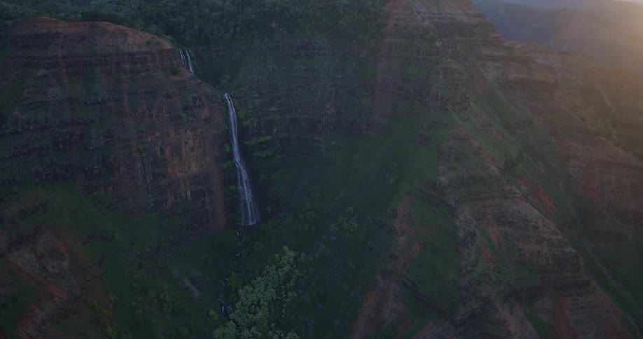 There is a waterfall on the side of the mountain