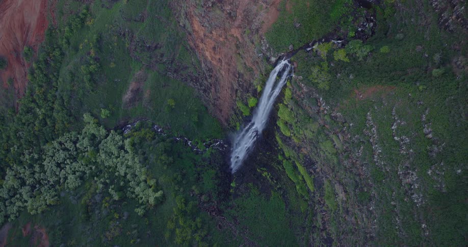 Waterfalls flow down and across the stepped cliffs