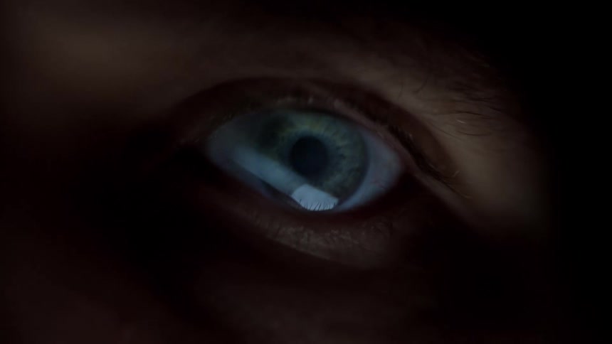 Closeup of a human eye partially illuminated in lowlight conditions