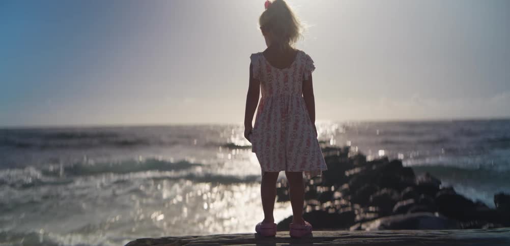 A child standing out at the beach