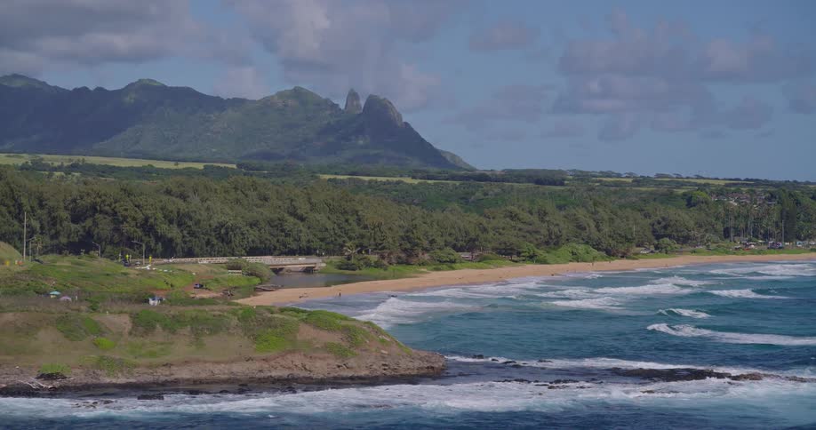 An aerial view of the coast with mountains in the distance