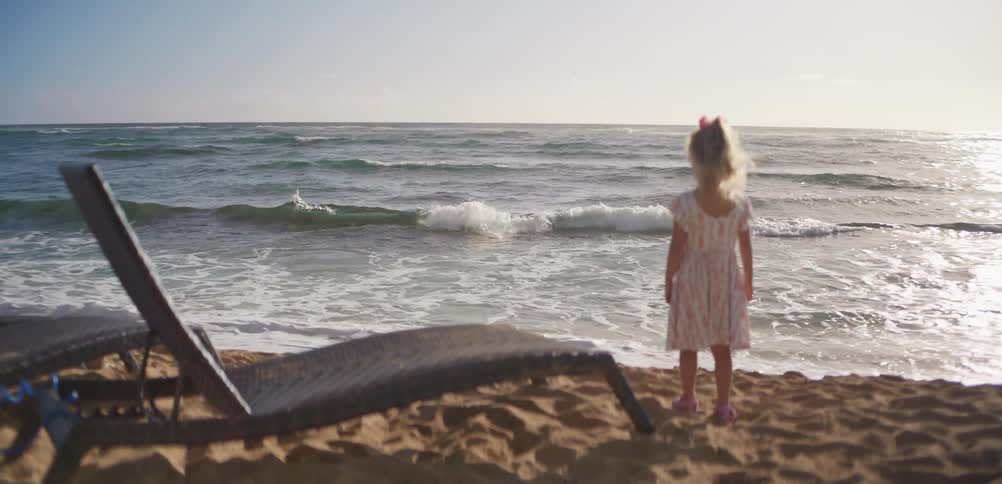 A child standing out on the beach