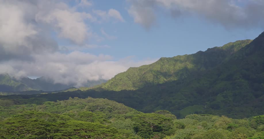 Forested mountains and valley under a cloudy sky