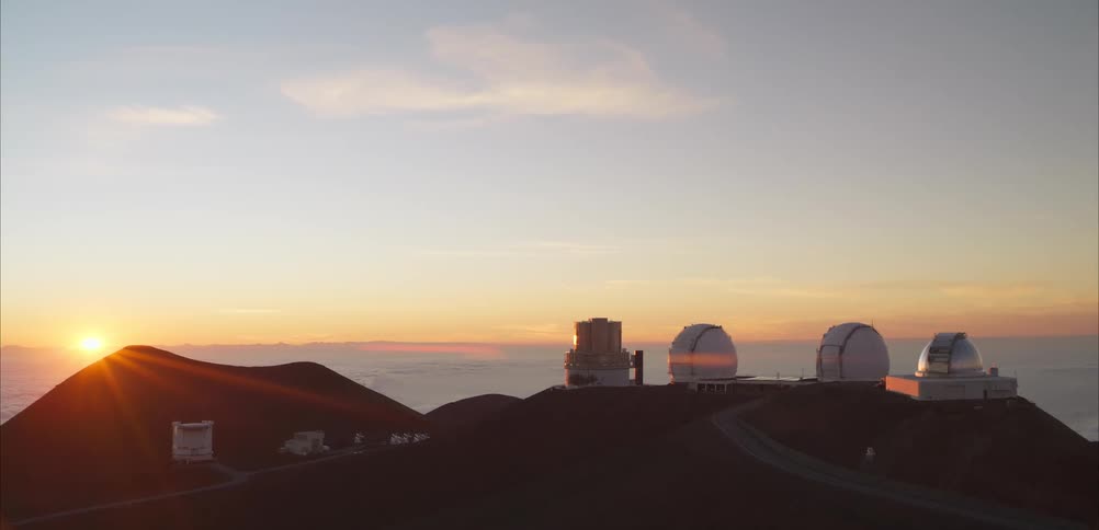 A view of some observatories at the top of a mountain