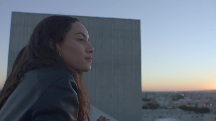 A woman outdoors at sunset