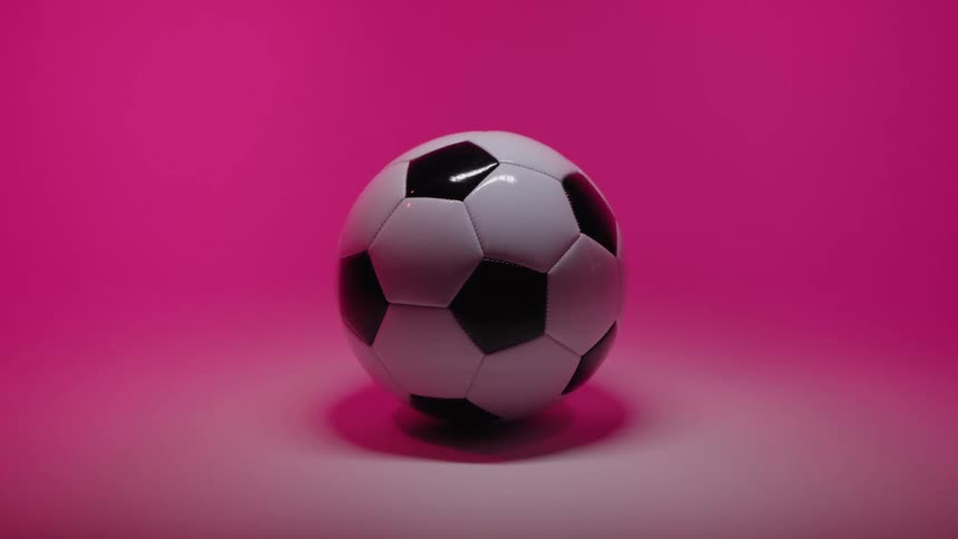 Soccer ball on the floor of a room with a pink glow