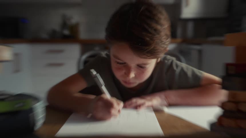A child writing on a piece of paper