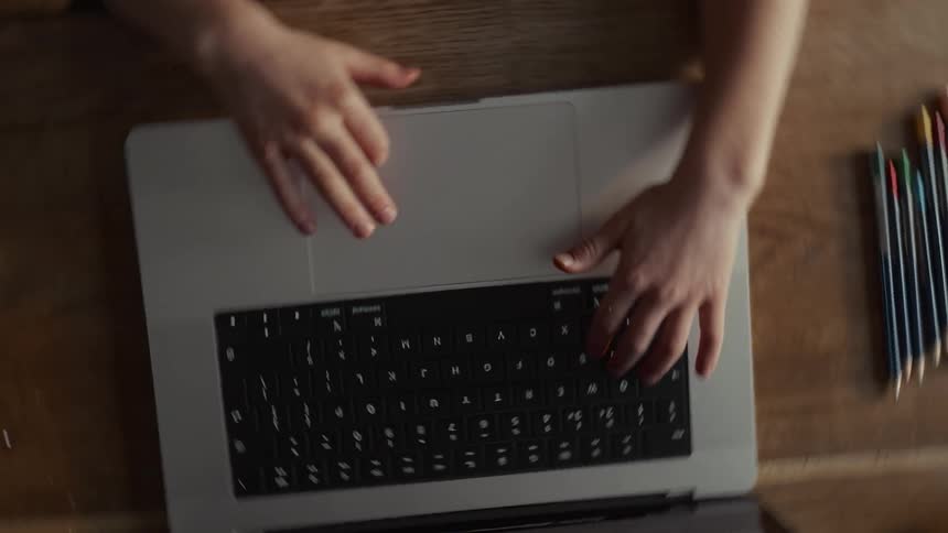 The boy is using his laptop at home