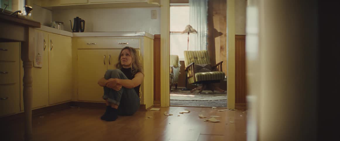 A woman sitting in a kitchen