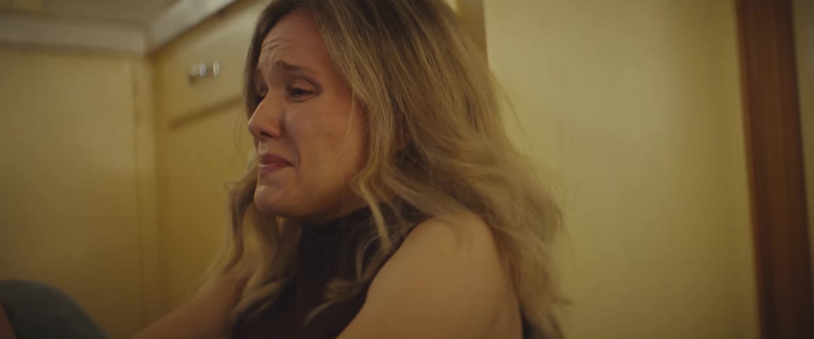 A woman crying sitting on the floor
