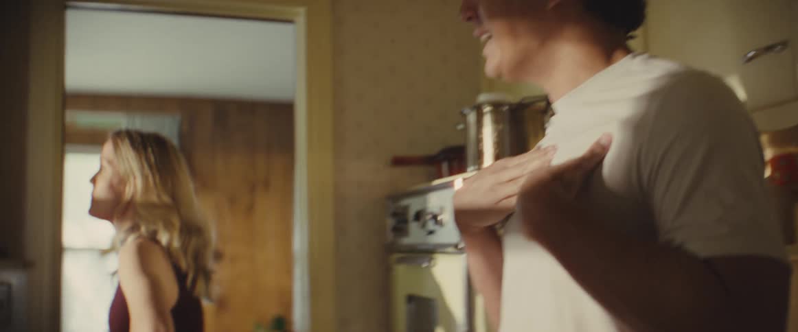 A man and woman arguing in a kitchen