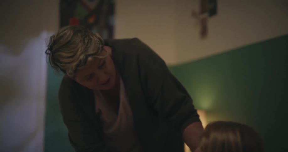 Grandmother putting her granddaughter to bed
