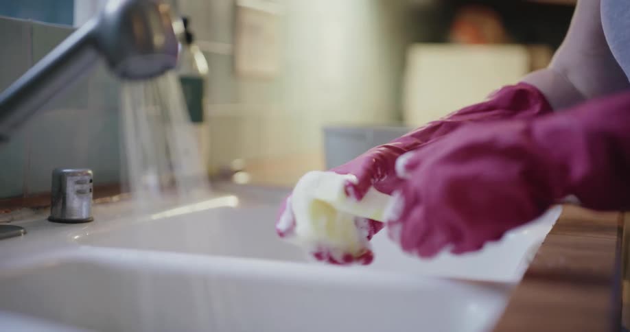 The woman squeezes the wet sponge and soap comes out