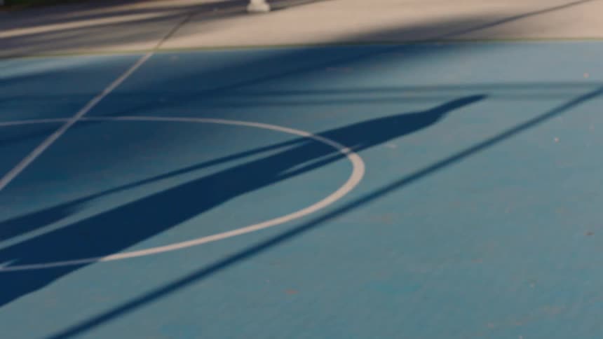 A man outdoors playing basketball