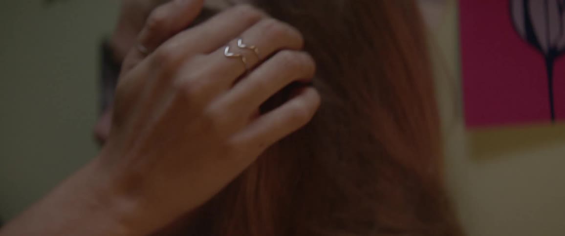 Woman caresses the hair of another woman