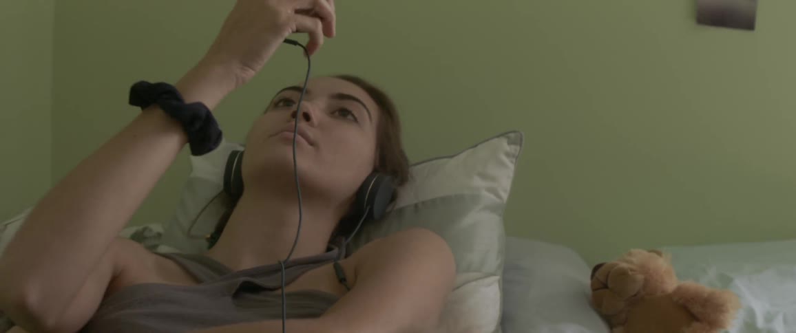 Two women relax on a bed