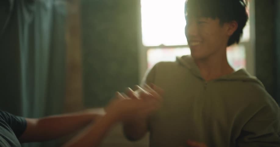 Person adjusts a childs hair indoors with natural light