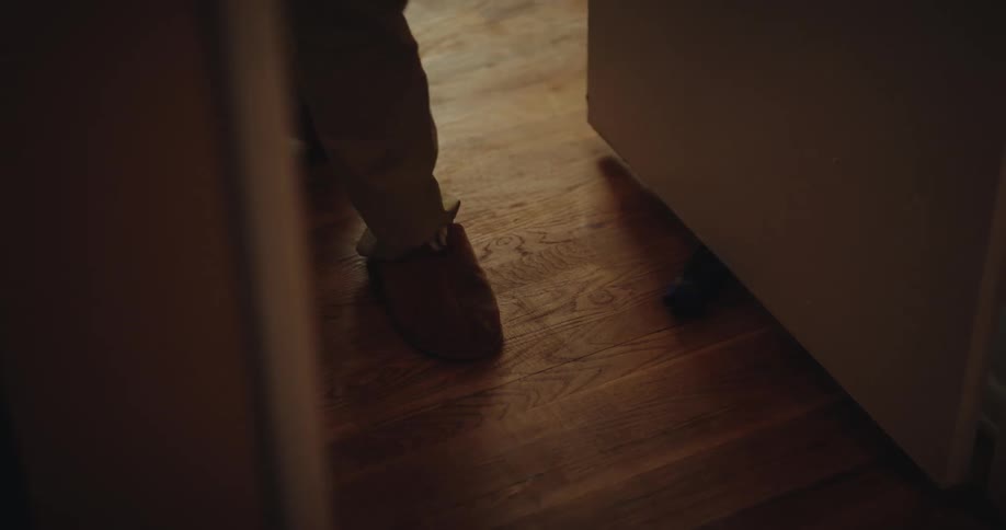 Person kicking a small toy car on the ground