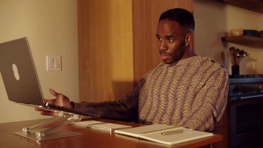 A man talking on a laptop