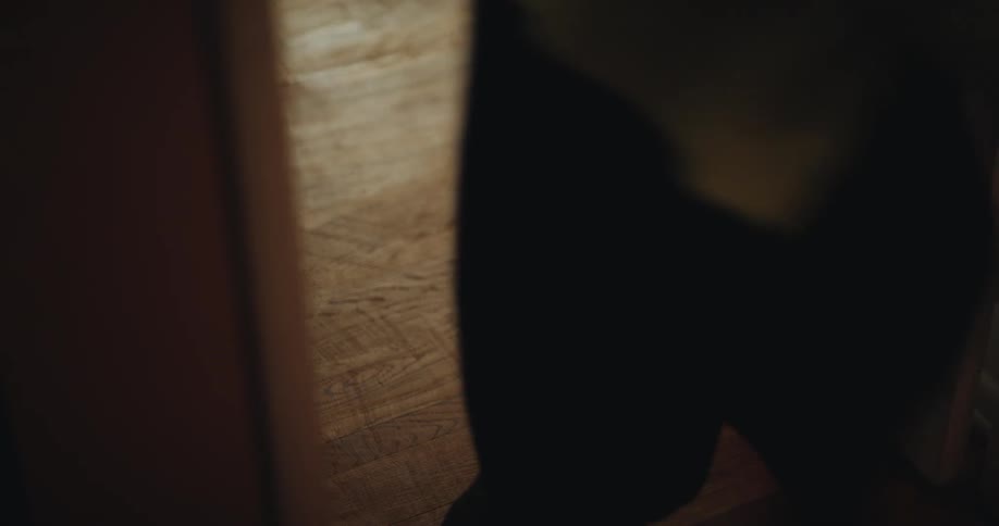 Mother and child run past an entrance indoors during daytime